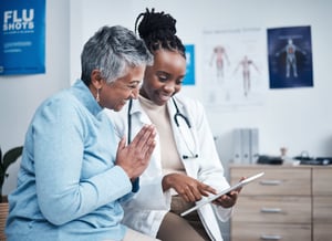 Doctor and senior patient with tablet, results and happy for health clearance, advice or report.