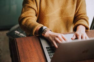 Female employee working on laptop from home
