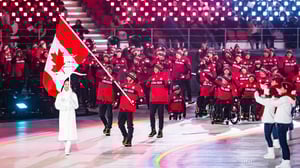 Group of Paralympic athletes at Pyeong Chang 2018 opening ceremony waving Canadian flag