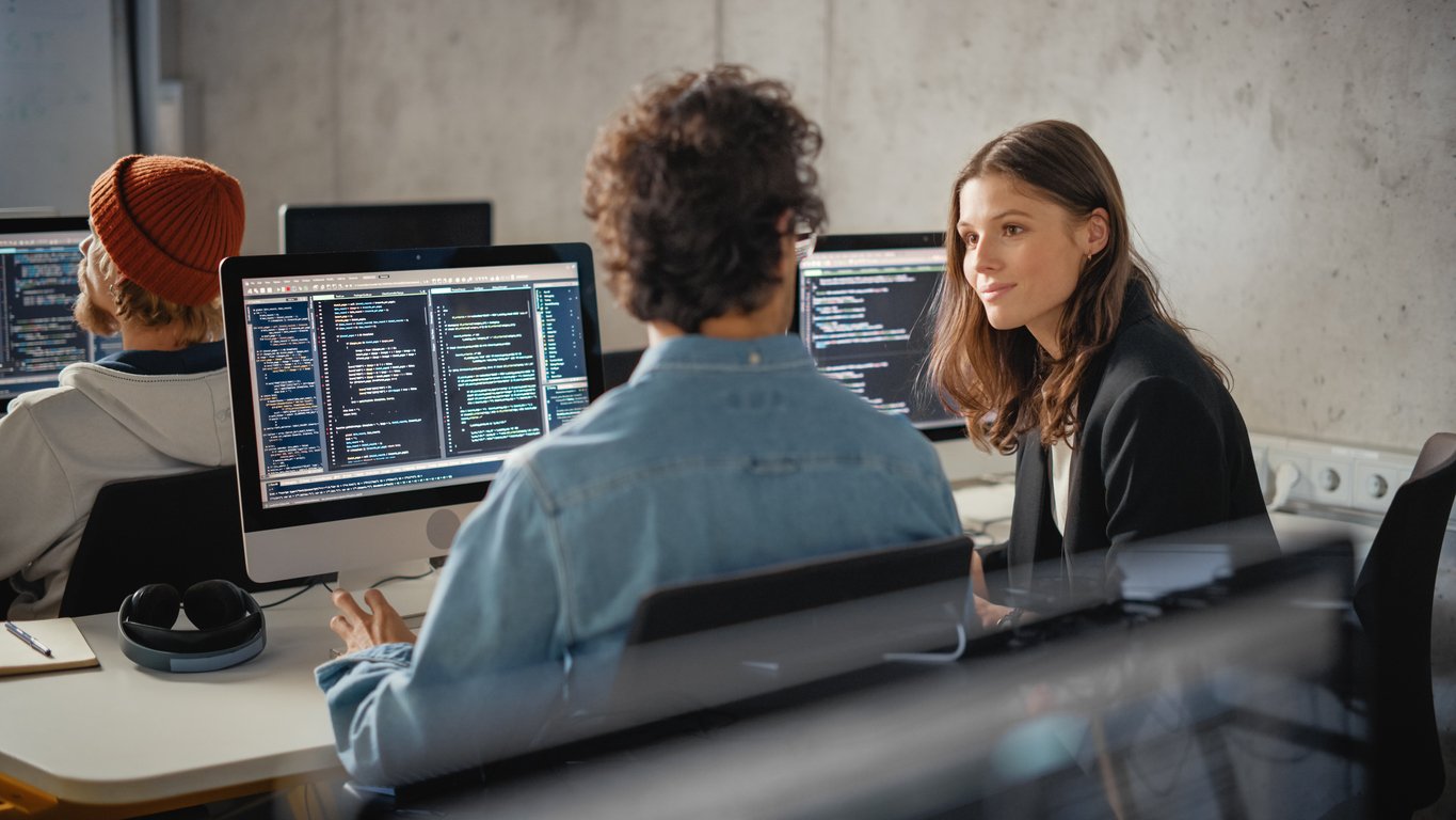 Two developers working on computer code