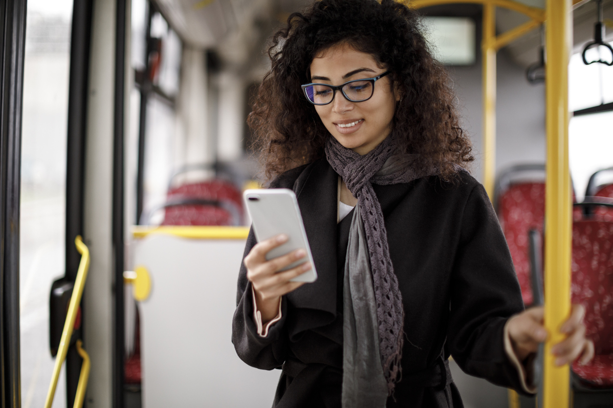 Woman on bus with smart phone