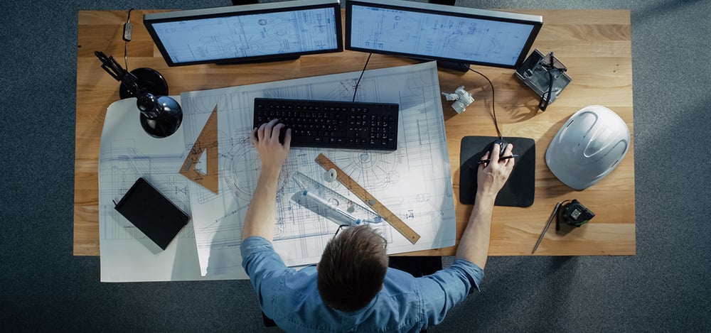 an engineer who is working at their desk.